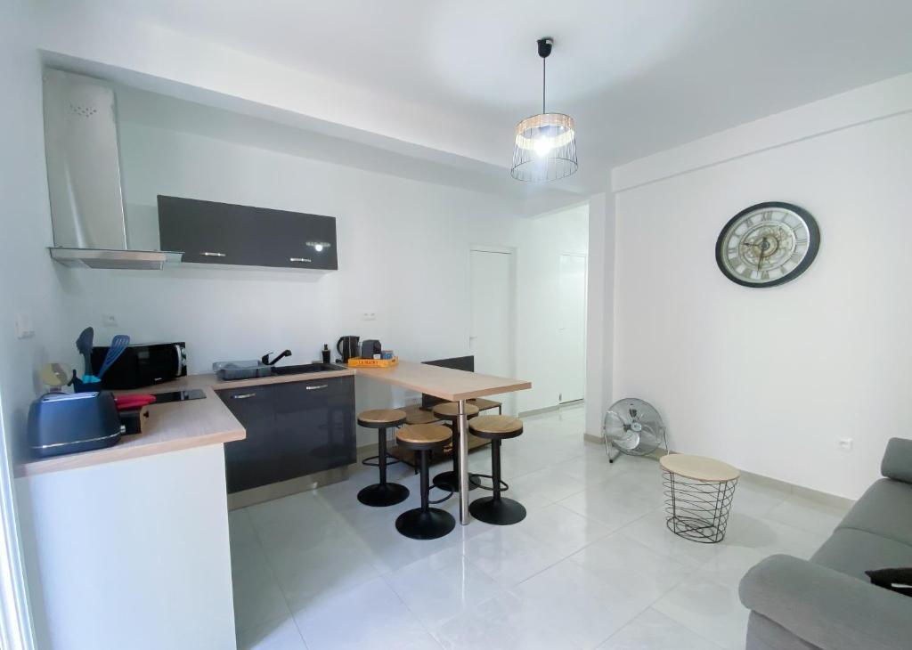 a kitchen with a table and chairs in a room at STE LUCE 50M DE LA MER APPT STANDING T2 3/4 PERS KAZ'ANTILLAISE in Sainte-Luce