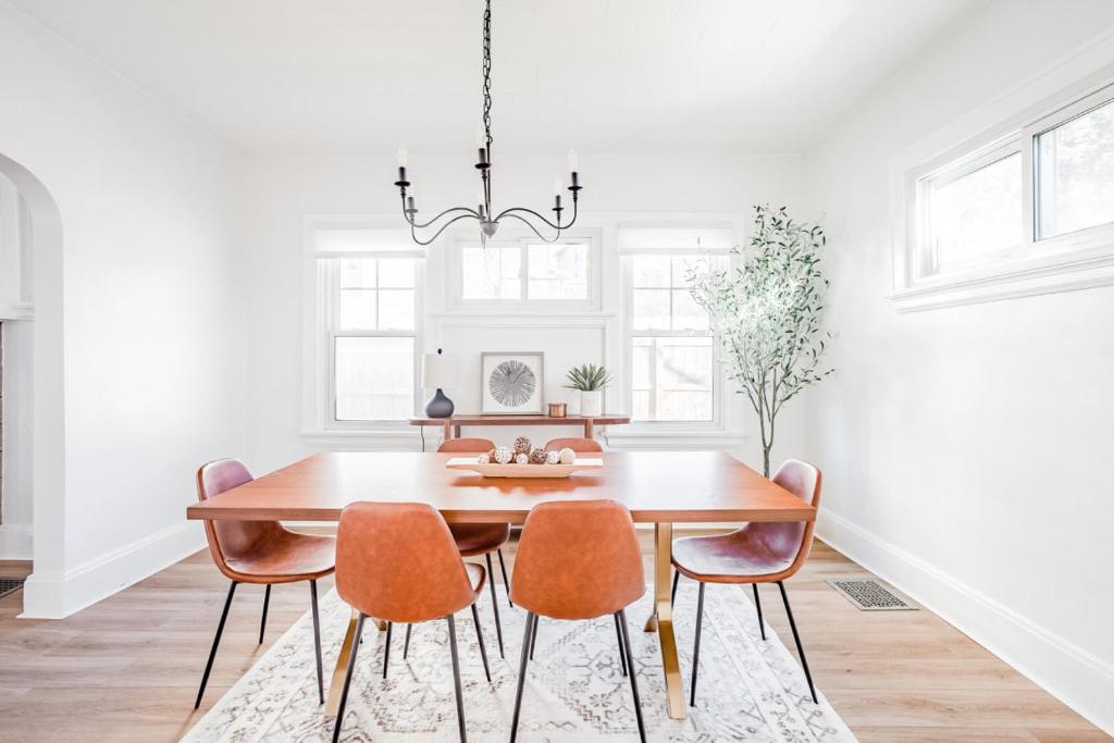 a dining room with a wooden table and chairs at Mid-Century Modern 2B Oakley with Fenced Yard and Offstreet Parking in Cincinnati