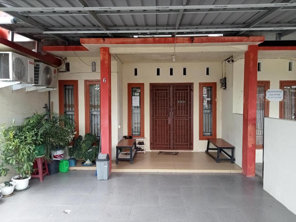 an entrance to a building with a red door at Penginapan Syari'ah Parak Anau in Tabing