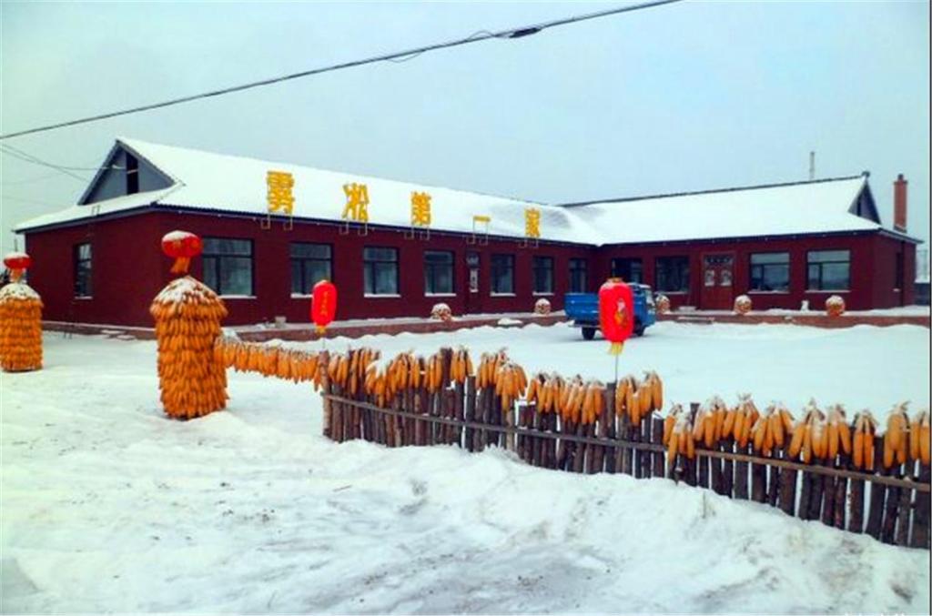a group of people in orange uniforms in the snow at Wusong Island Wusong Country House in Jilin