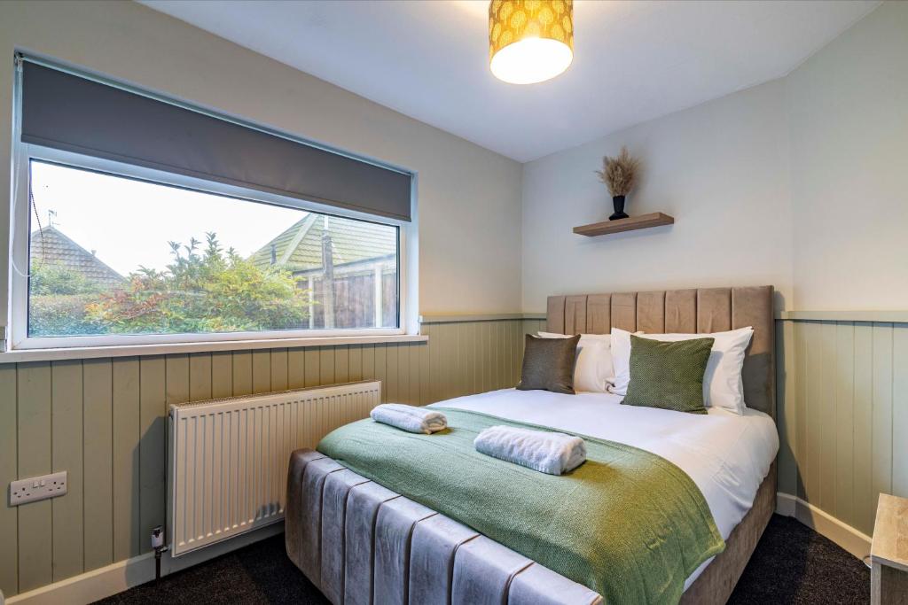 a bedroom with a bed with a large window at 2 bed home Walking distance to QMC in Nottingham