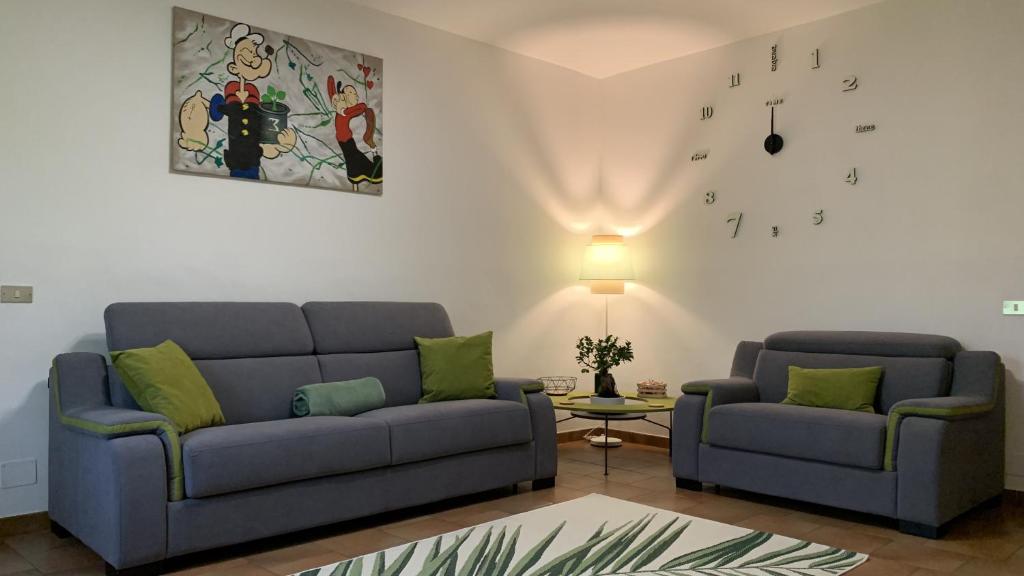 sala de estar con 2 sofás azules y reloj en BB • Tree en Candelo