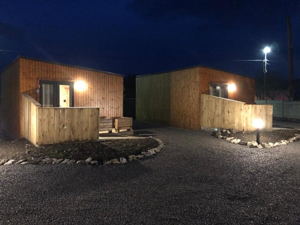 a couple of buildings at night with lights at Neadín Beag in Tralee