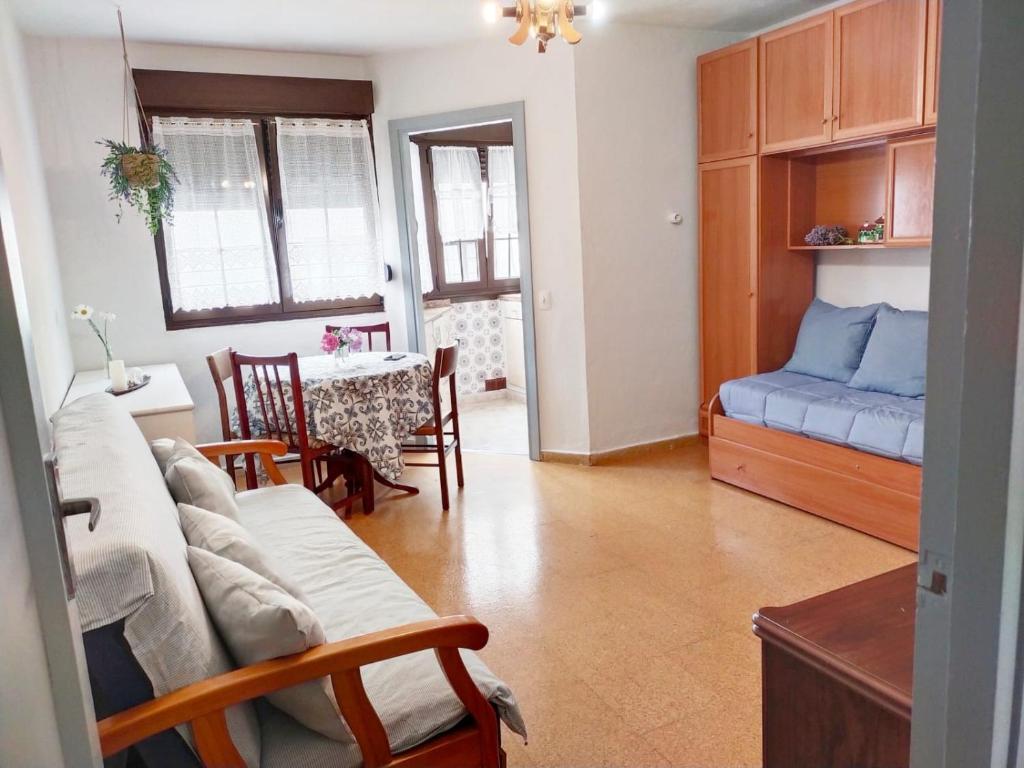 een woonkamer met een bank en een tafel bij El refugio de lastres in Lastres