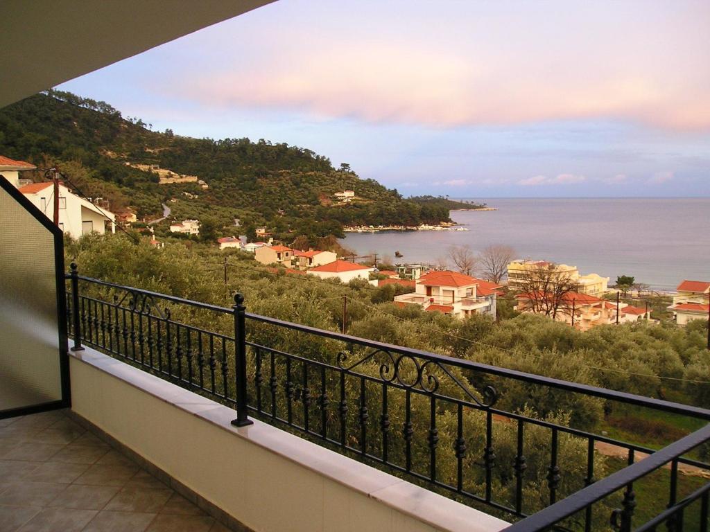 a balcony with a view of the ocean at Golden Beach Inn in Chrysi Ammoudia