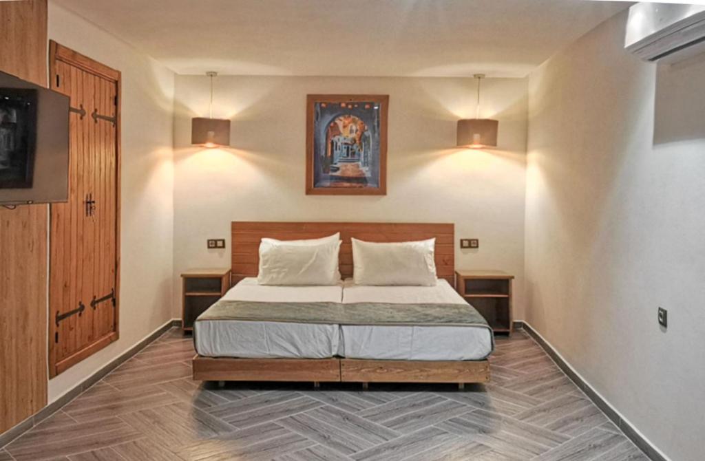 Postel nebo postele na pokoji v ubytování Aparthotel Dar Nowara Chaouen