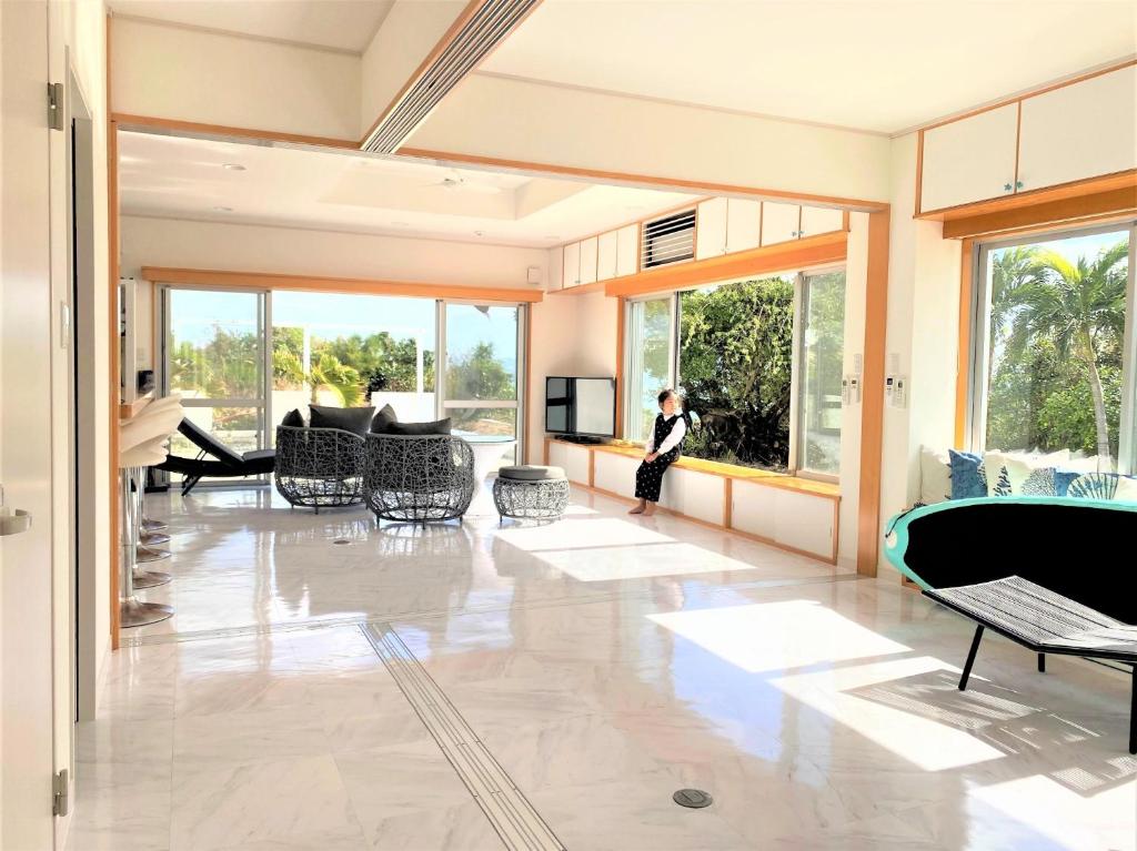 a woman is standing in a living room at Ie shima-MONKEY - Vacation STAY 48431v in Ie