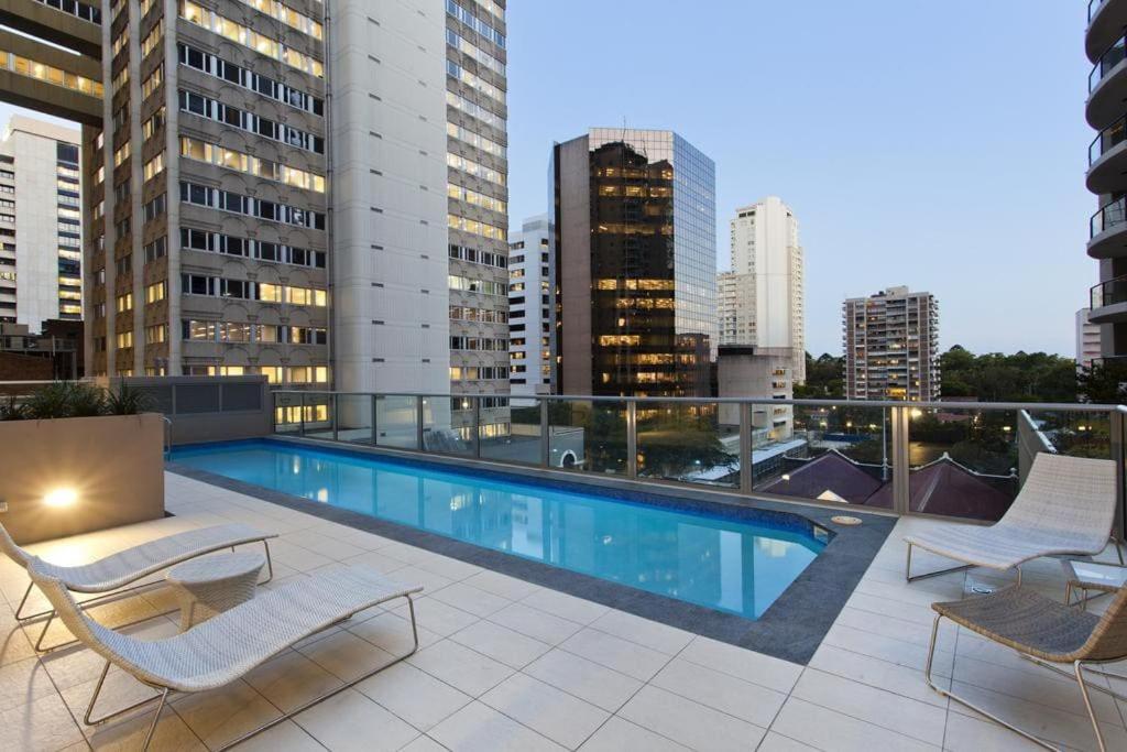 a swimming pool on the roof of a building at CBD studio with balcony+pool+gym+sauna in Brisbane