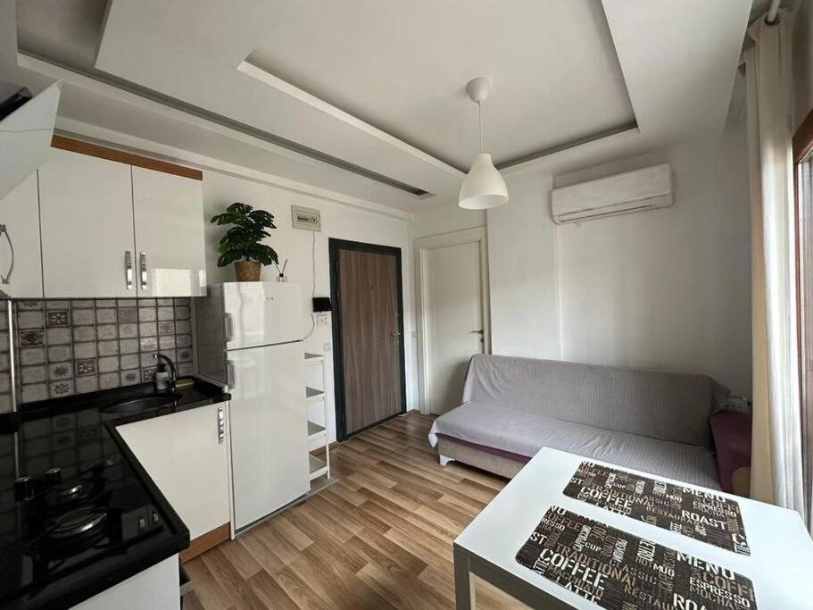 a kitchen and a living room with a couch at Deniz One Bedroom Appartment in Mezitli