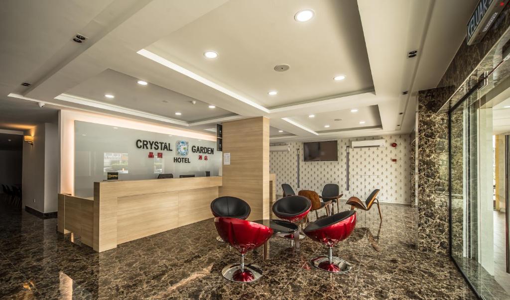 a waiting room with red chairs and a counter at Crystal Garden Hotel - Seri Kembangan in Seri Kembangan