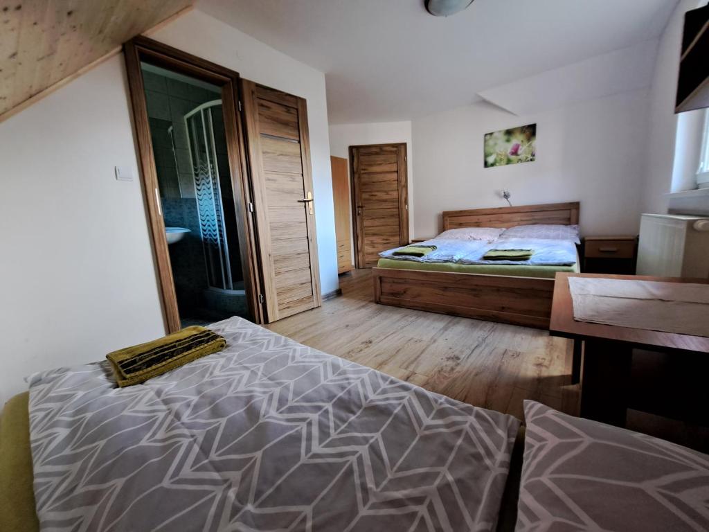 a bedroom with a bed and a wooden floor at Chata Berešík in Terchová