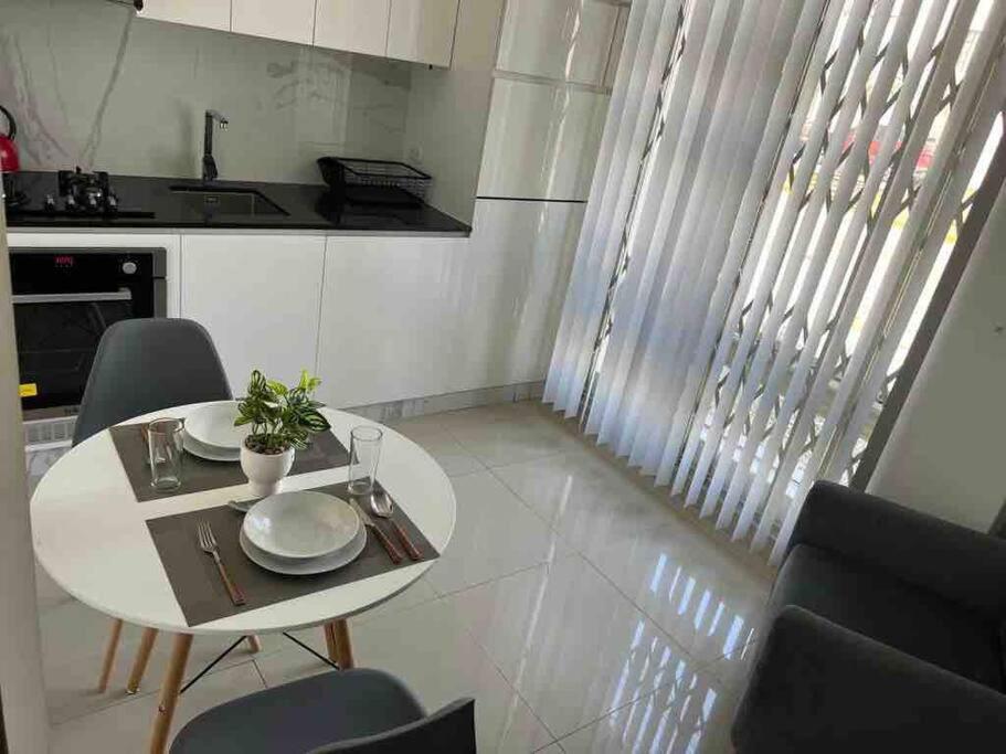 a small white table and chairs in a kitchen at '' SIÉNTETE EN CASA '' acogedor y en la mejor zona in Trujillo