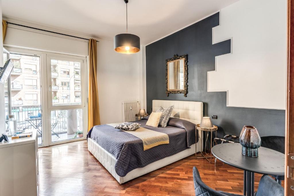 um quarto com uma cama e uma mesa em Stasera a casa da M.E. em Roma