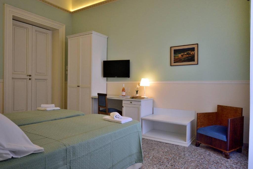 Postel nebo postele na pokoji v ubytování Bellini Inn Deluxe