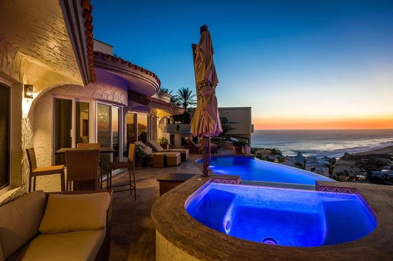 a house with a large blue tub in a yard at Sunset View Villa Pedregal in Cabo San Lucas