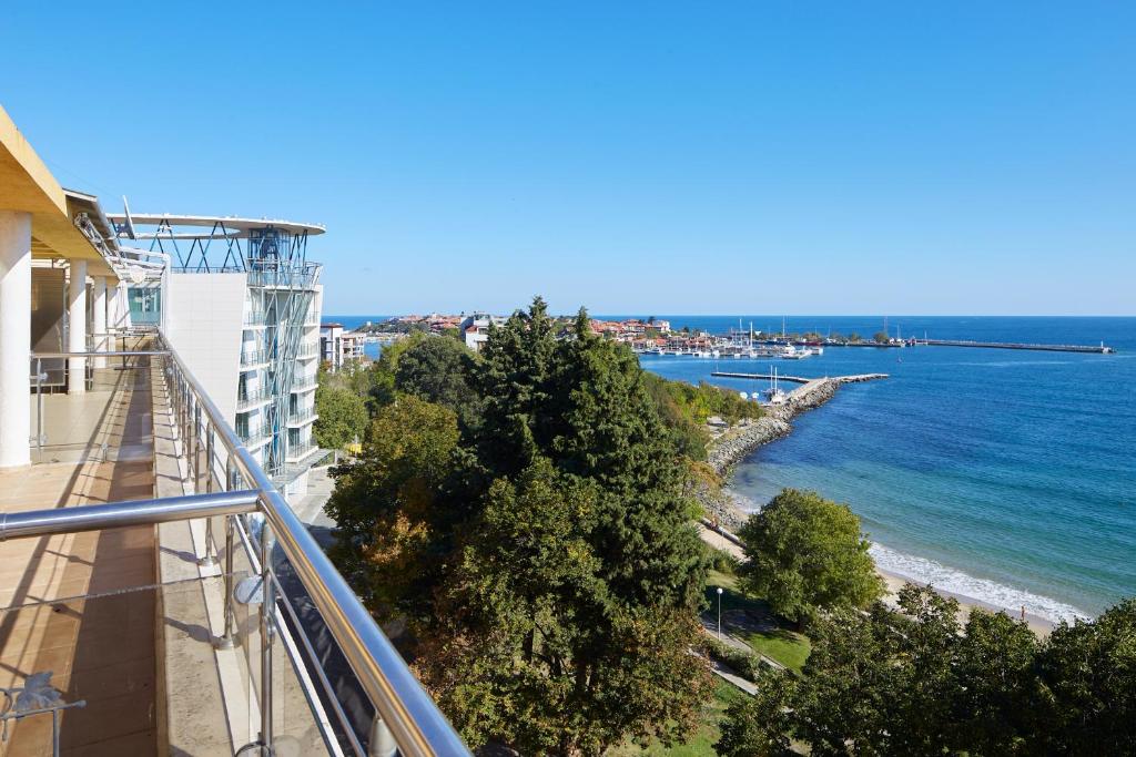 a view of the ocean from a balcony of a building at Infinity Apartment Nessebar in Nesebar