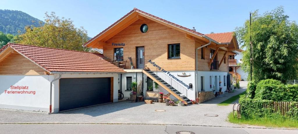 a large house with a garage and a house at Ferienwohnung Birkennest in Bad Heilbrunn
