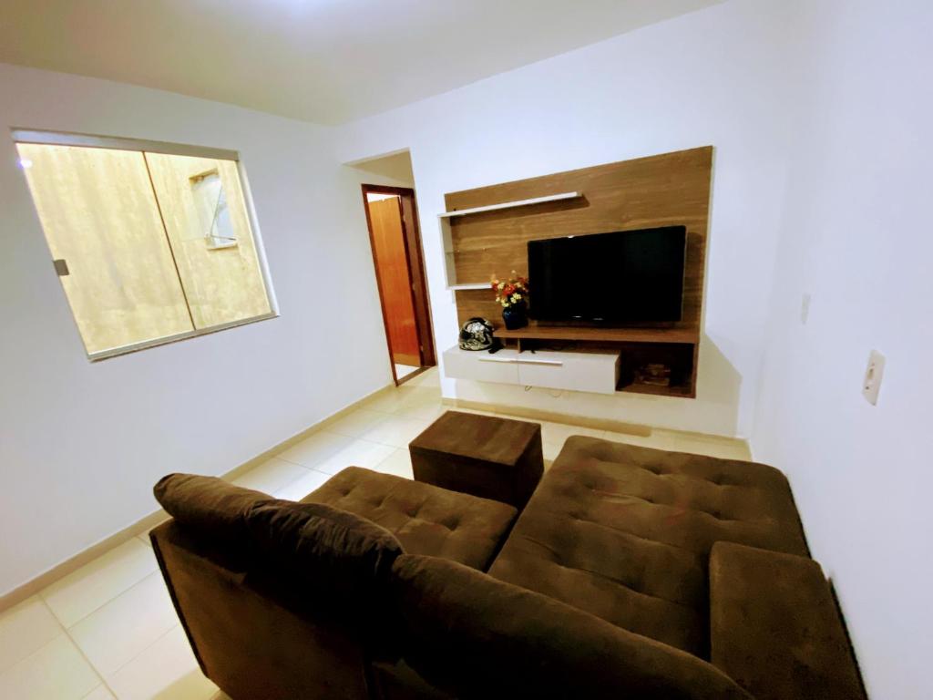 a living room with a couch and a flat screen tv at Samambaia QI 616 in Brasilia