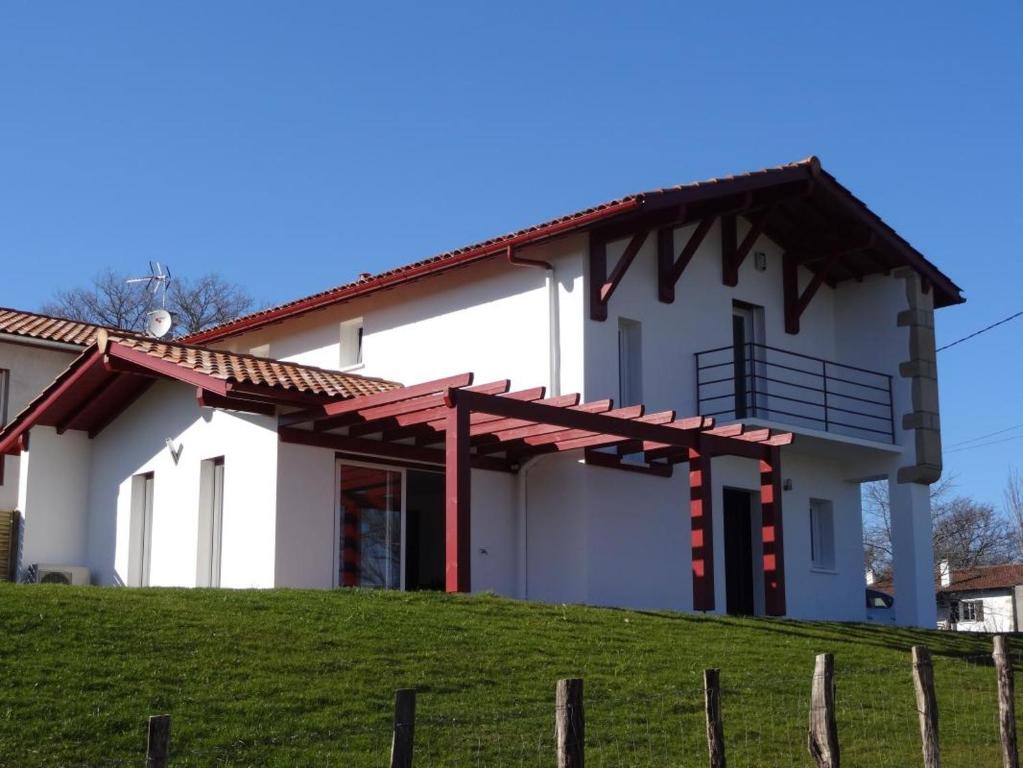 a white house with a red roof at Larralde-beherria in Itxassou