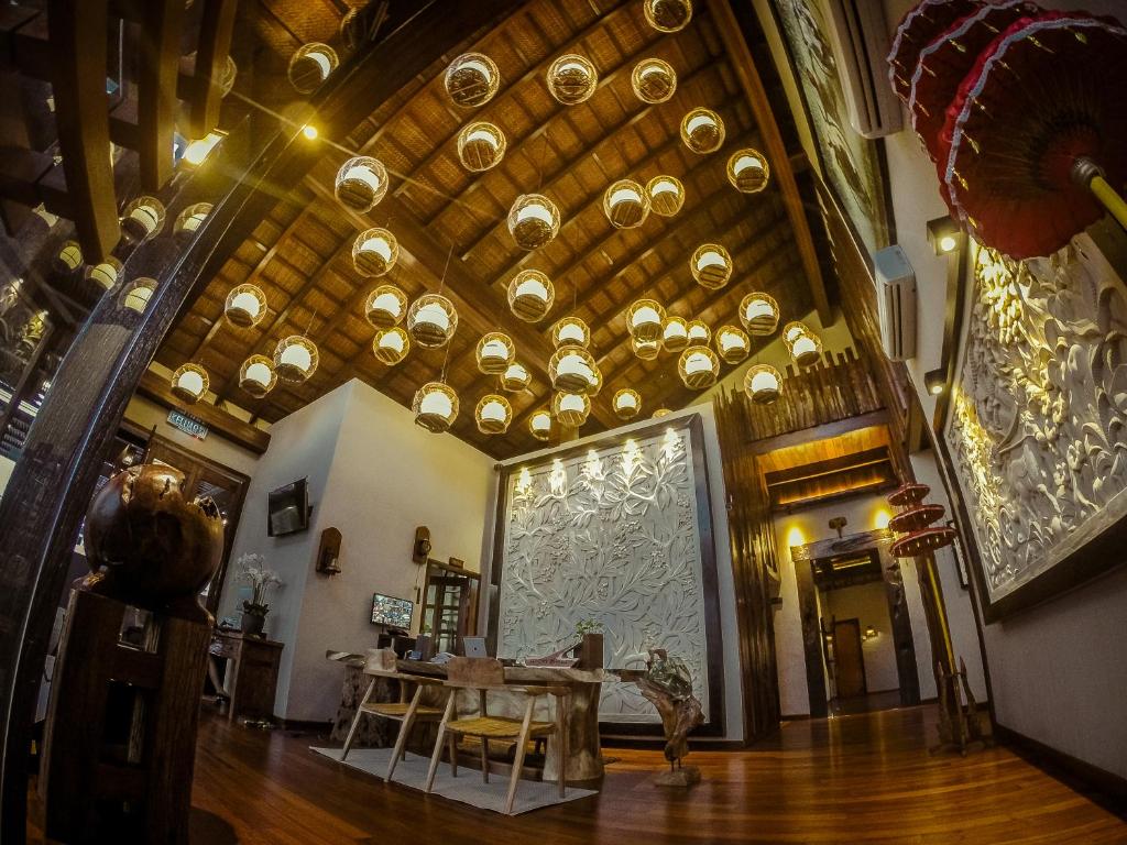 a room with a table and a ceiling with bowls at Ipoh Bali Hotel in Ipoh