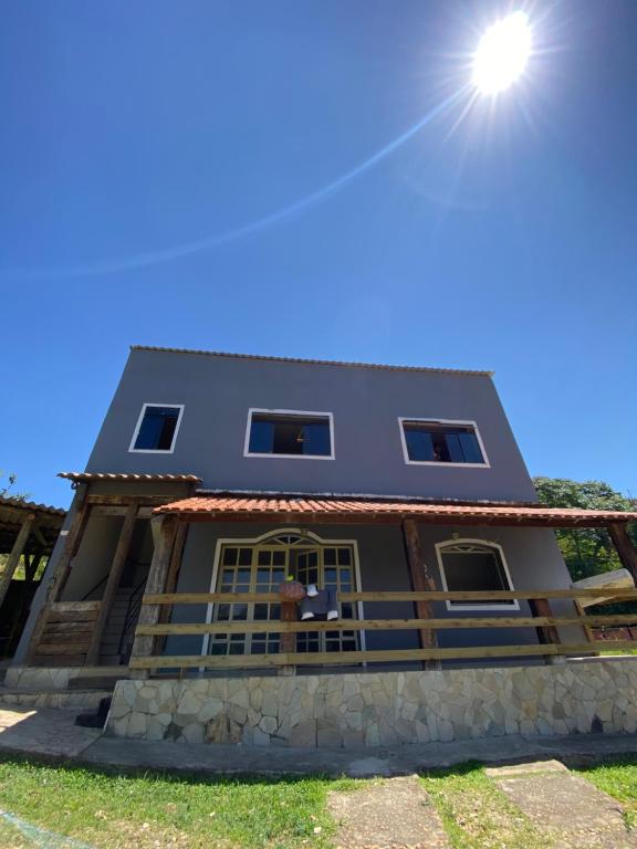 a house with the sun in the sky at Casa Buena Vibra Hostel in São João del Rei