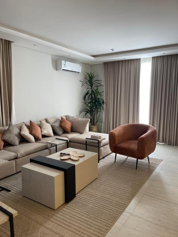 a living room with a couch and a chair at A luxury three-bedroom apartment in the heart of Riyadh in Riyadh