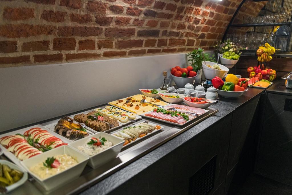 a buffet line with many different types of food at Hotel Logos Kraków in Krakow