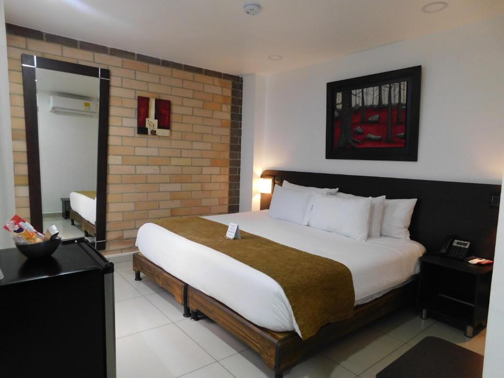 Postel nebo postele na pokoji v ubytování Hotel Acqua Medellín