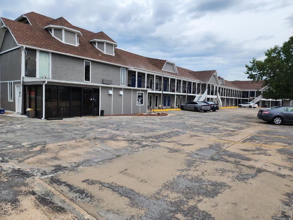 a large building with cars parked in a parking lot at Carthage Inn in Carthage
