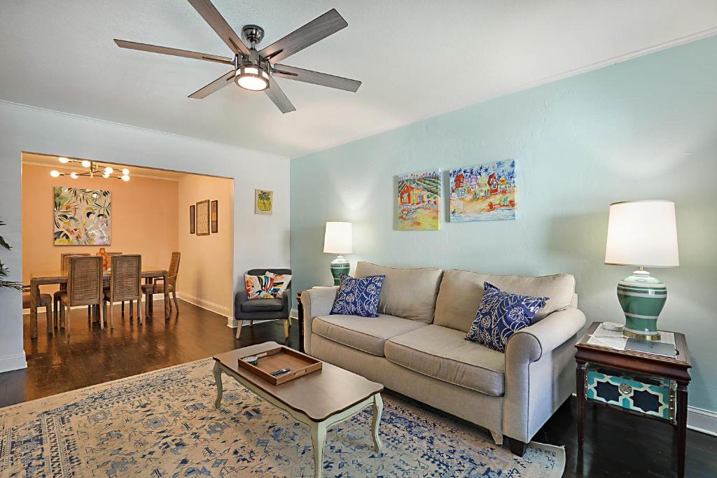a living room with a couch and a ceiling fan at Steps to Beach & Downtown! Spacious Beach Bungalow #2 in Lake Worth