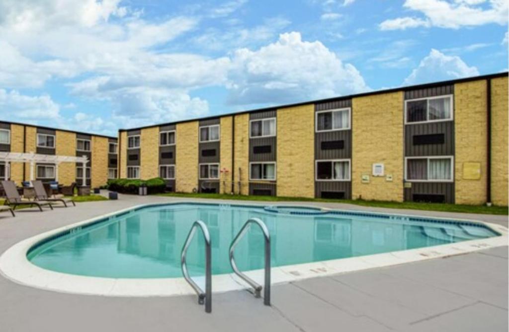 a large swimming pool in front of a building at SureStay Plus Hotel by Best Western McGuire AFB Jackson in Cookstown