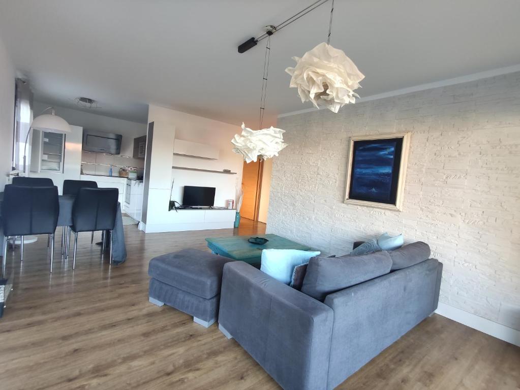 a living room with a blue couch and a table at Bella Vista - New flat with View Confort & Calm near Geneva 5 PERS in Archamps
