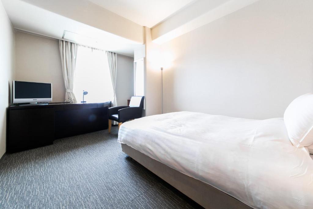 Postel nebo postele na pokoji v ubytování Hotel Crystal Palace