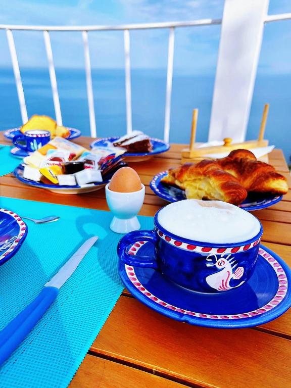 a table with plates of food and eggs on it at B&B Il Paradiso di Capri in Anacapri