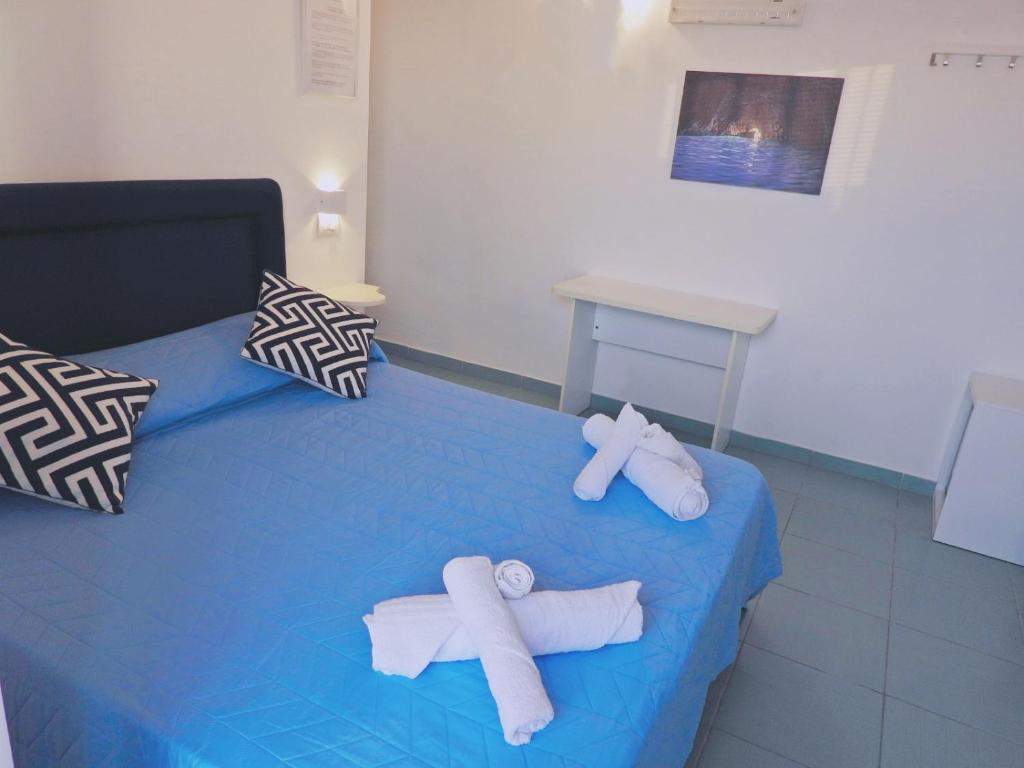 two towels on a blue bed in a room at B&B Il Paradiso di Capri in Anacapri