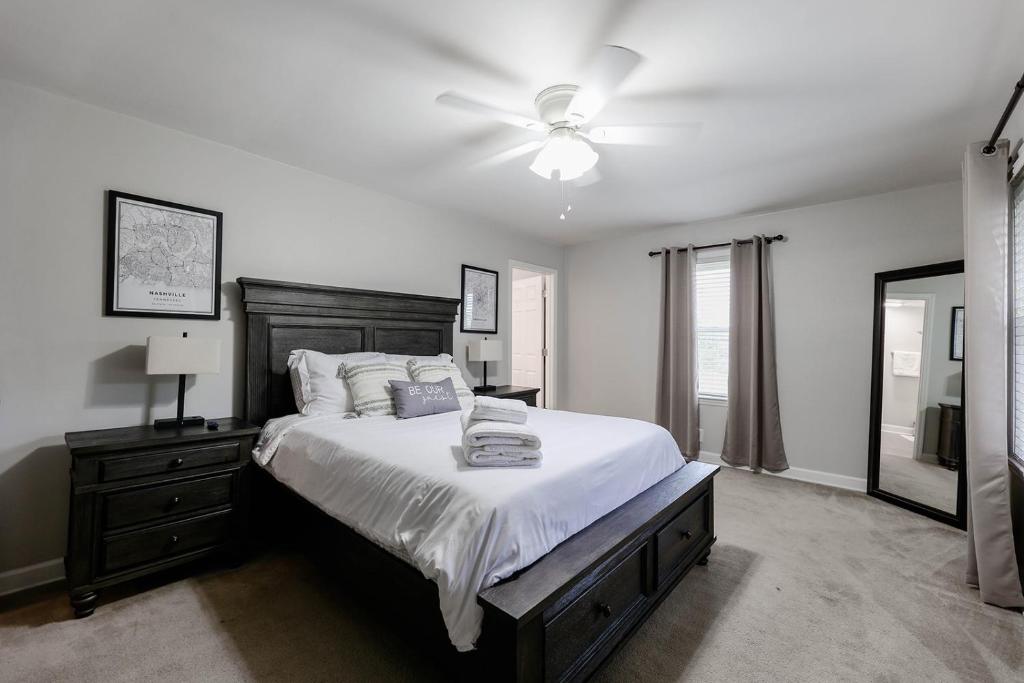 a bedroom with a bed and a ceiling fan at Rockin' West Nashville Retreat - 5 miles from downtown in Nashville