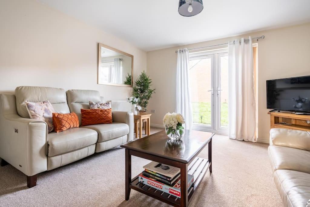 a living room with a couch and a coffee table at Grenadier House in Coventry