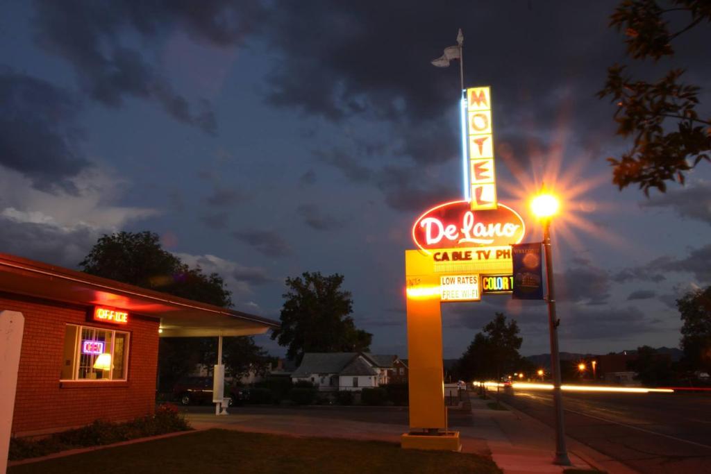 a neon sign for a dixie motel on a street at DeLano Motel & RV Park Beaver in Beaver