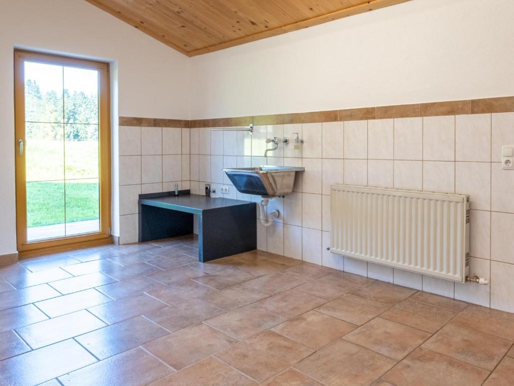 a bathroom with a sink and a counter and a window at Obinghof in Söll