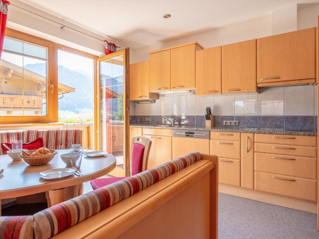 a kitchen with a table and a dining room at Obinghof in Söll