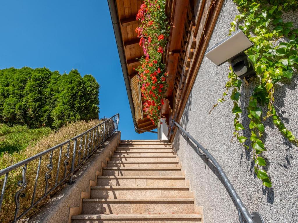 a stairway with flowers on a building at Obinghof in Söll