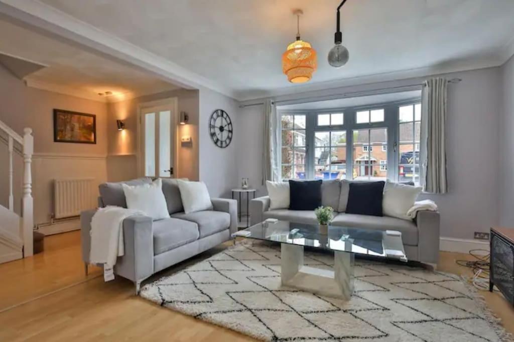 a living room with a couch and a table at Large 4 Bed House near River Thames in Old Windsor