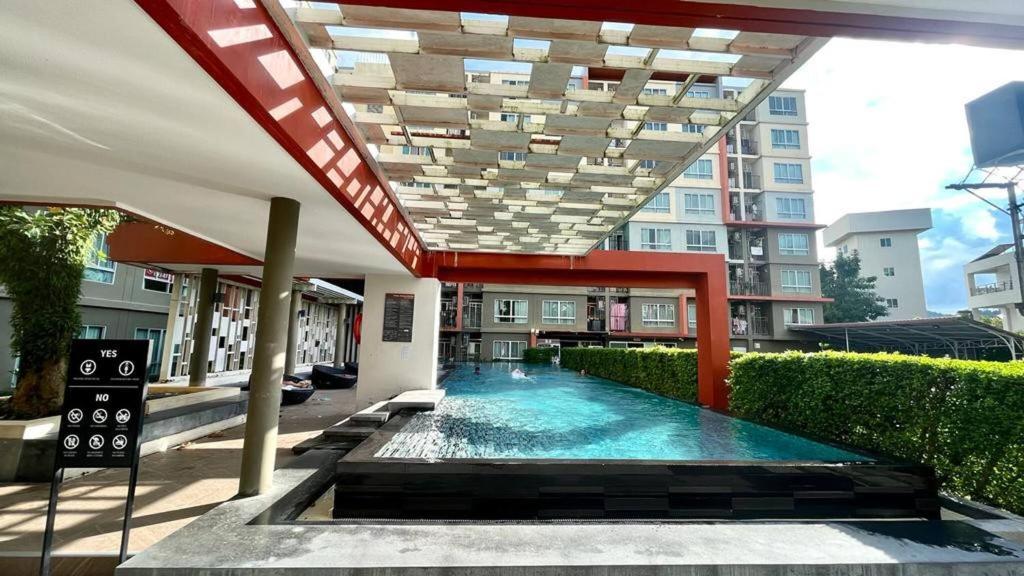 a swimming pool in the middle of a building at Dcondo Kathu - Top Floor 1 Bdr Condo with shared Pool in Kathu