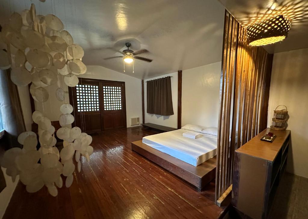 a bedroom with a bed and a large mirror at Tribal Xperience Guesthouse in San Vicente