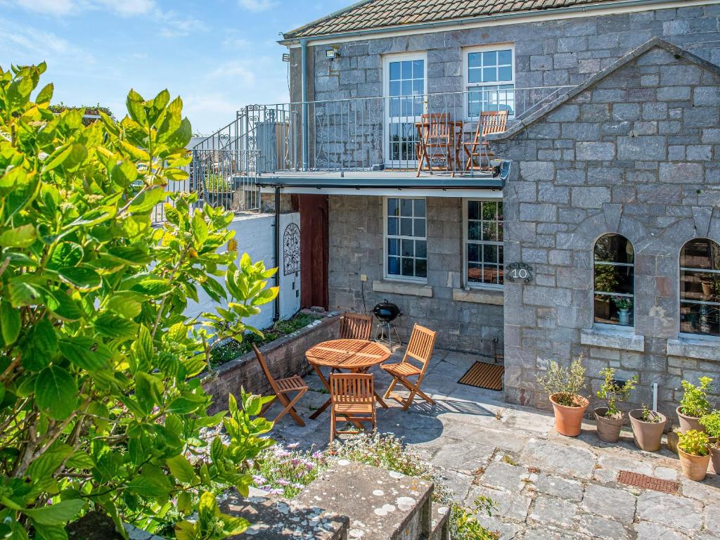 a patio with chairs and a table in front of a building at The Old Canoe Club in Millbrook