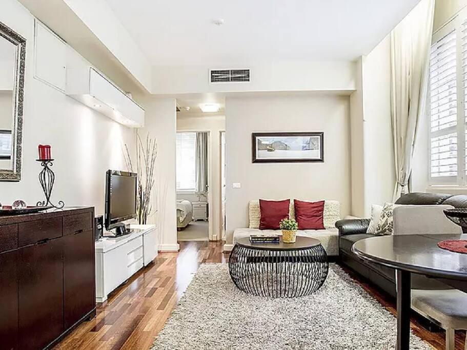 a living room with a couch and a table at Inner City 2 Bedroom Apartment Self Catering in Sydney
