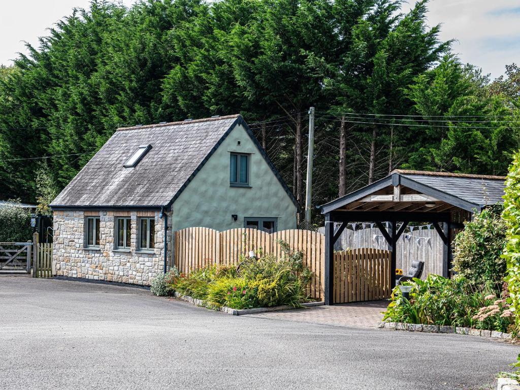 a small house with a gate and a wooden fence at Little Willow in Saint Columb Major