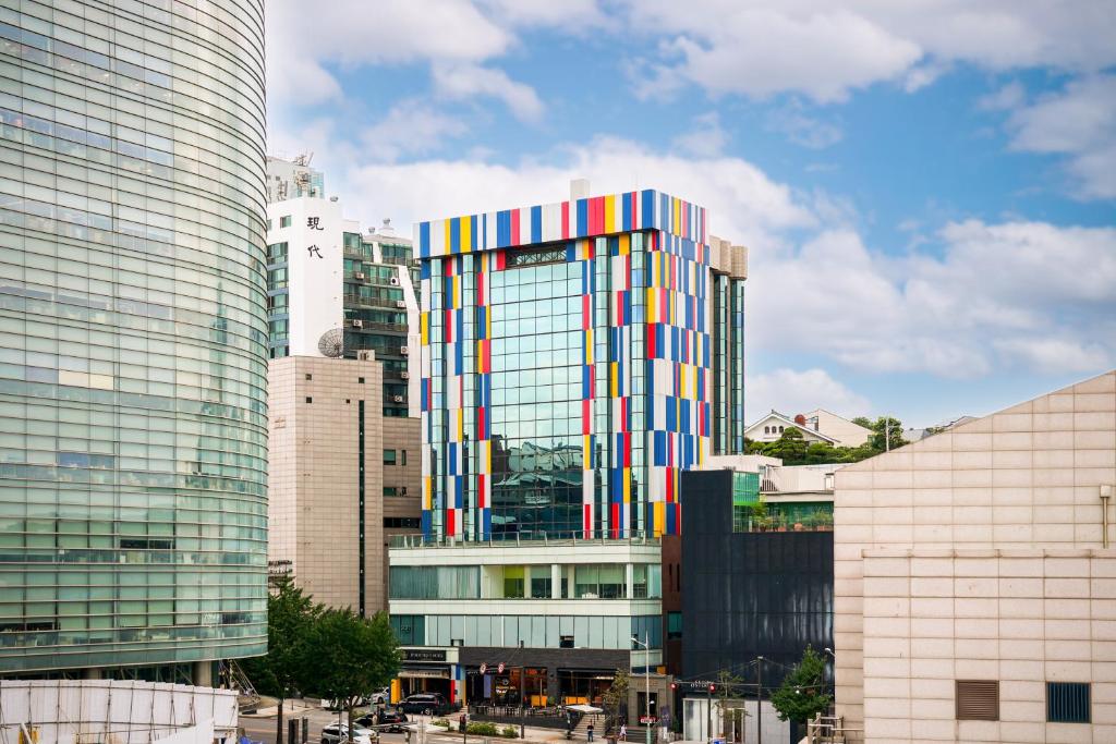 a tall building with a colorful facade in a city at Imperial Palace Boutique Hotel Itaewon in Seoul