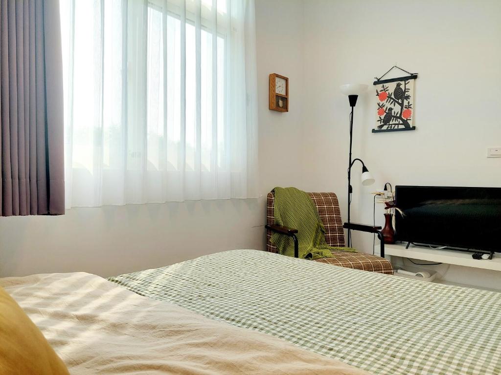 Ένα ή περισσότερα κρεβάτια σε δωμάτιο στο Xinhouse Homestay