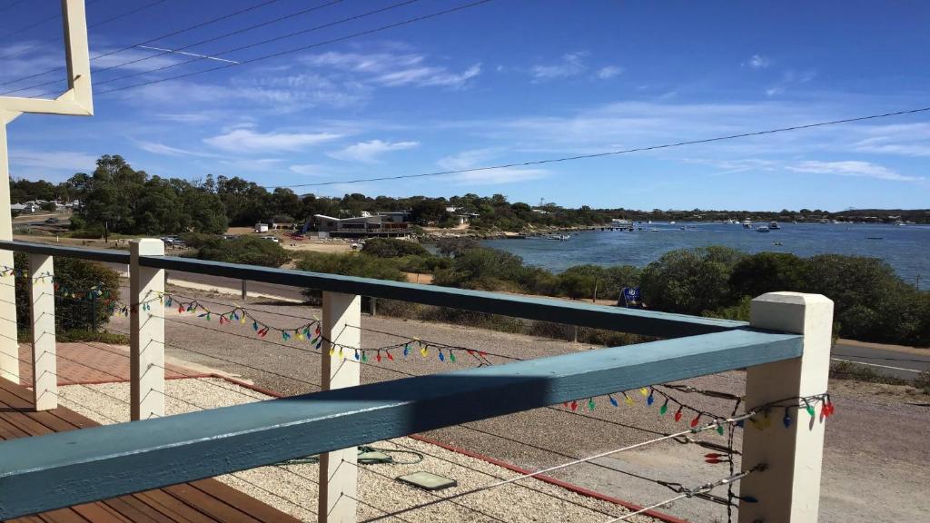 a balcony with a view of the water with flags at Seascape in Coffin Bay